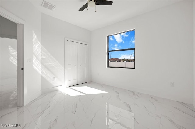 unfurnished bedroom with a closet and ceiling fan