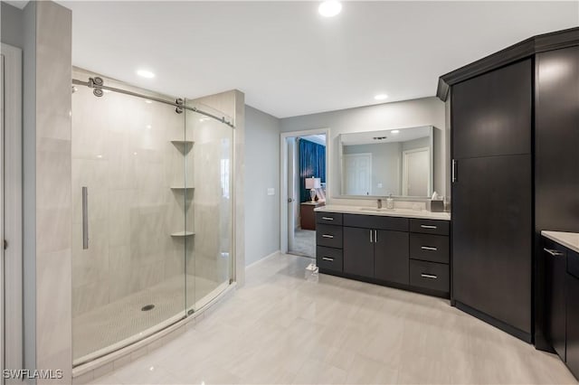 bathroom with vanity and an enclosed shower