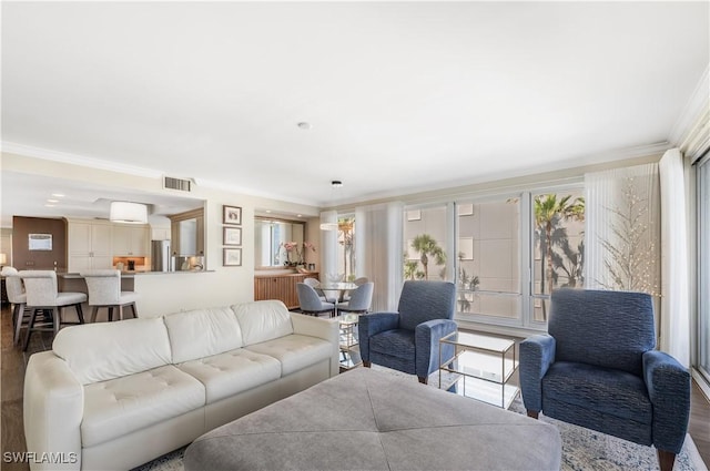 living room featuring hardwood / wood-style flooring and crown molding