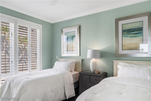 bedroom featuring multiple windows and crown molding