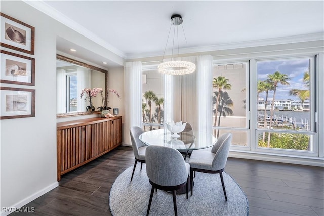 dining space featuring crown molding, dark hardwood / wood-style floors, and a chandelier