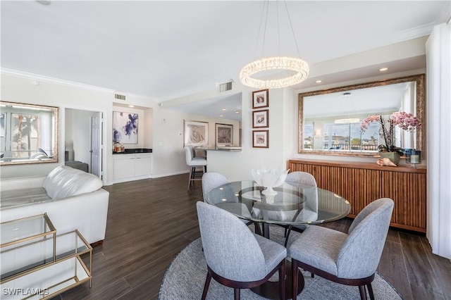 dining room featuring dark wood-type flooring and crown molding