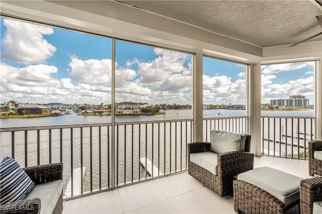 sunroom / solarium with a water view