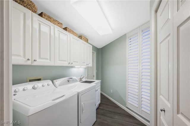 laundry area with sink, dark wood-type flooring, washing machine and dryer, and cabinets