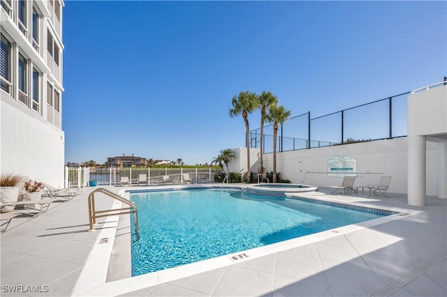 view of pool with a community hot tub and a patio