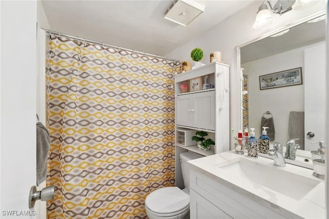 bathroom featuring a shower with shower curtain, toilet, and vanity