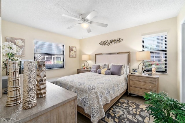 bedroom with a textured ceiling, a ceiling fan, and wood finished floors