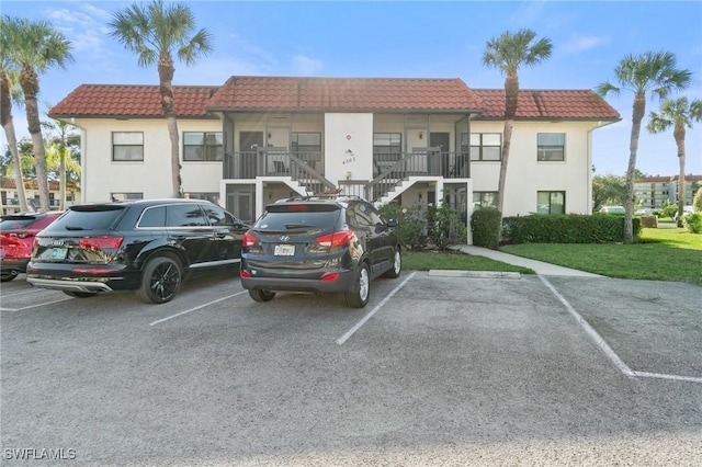 exterior space with stairway and uncovered parking