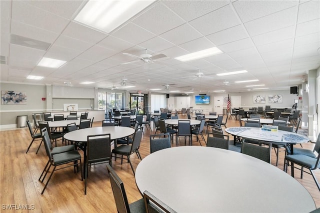 dining area featuring visible vents, light wood-style flooring, and a paneled ceiling