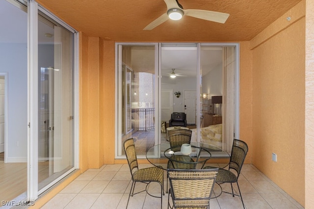 sunroom / solarium featuring ceiling fan