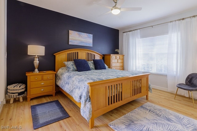 bedroom with light hardwood / wood-style floors and ceiling fan