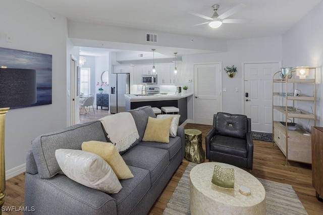 living room featuring hardwood / wood-style floors and ceiling fan