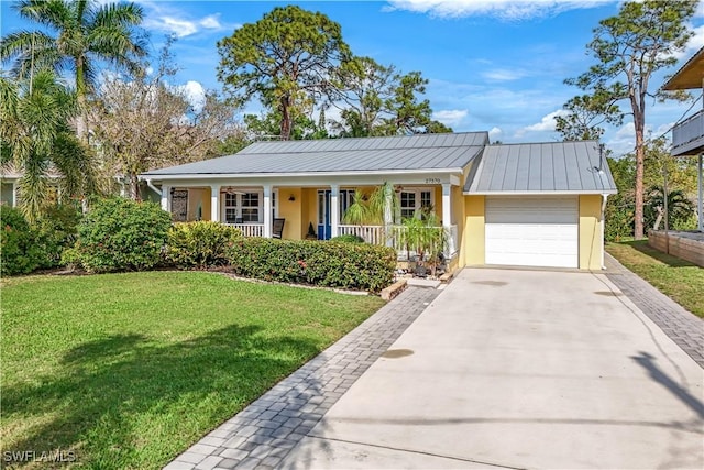 ranch-style home featuring a porch, an attached garage, concrete driveway, stucco siding, and a front yard