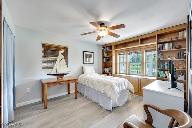 bedroom featuring light wood-type flooring and baseboards