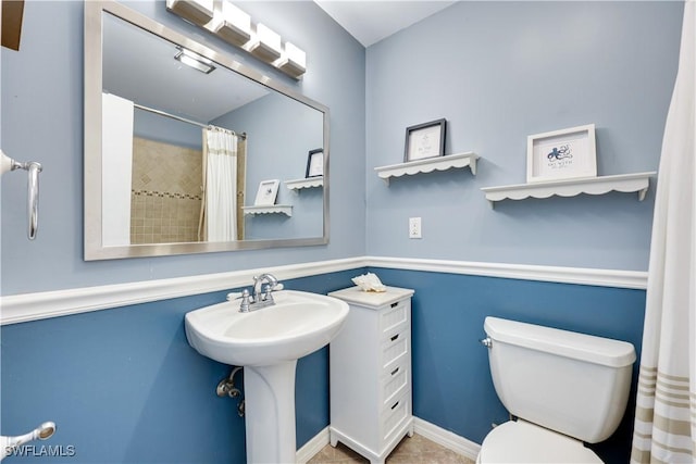 bathroom featuring curtained shower and toilet