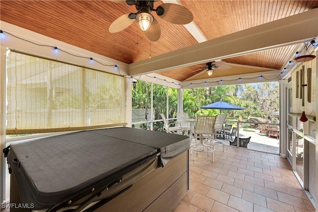 view of patio / terrace with ceiling fan, outdoor dining area, fence, and a hot tub