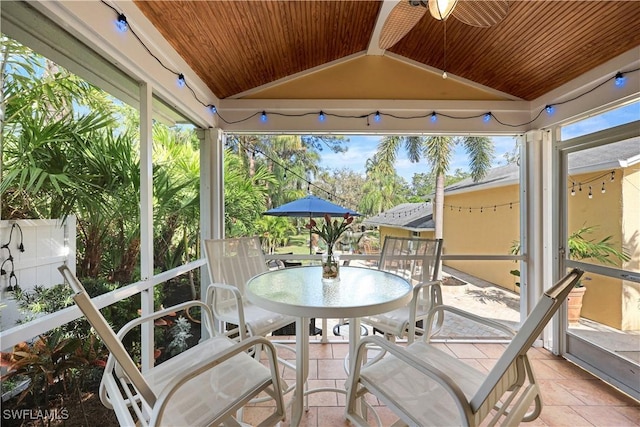 sunroom / solarium featuring lofted ceiling, ceiling fan, a wealth of natural light, and wood ceiling