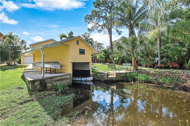 exterior space featuring a water view and stucco siding