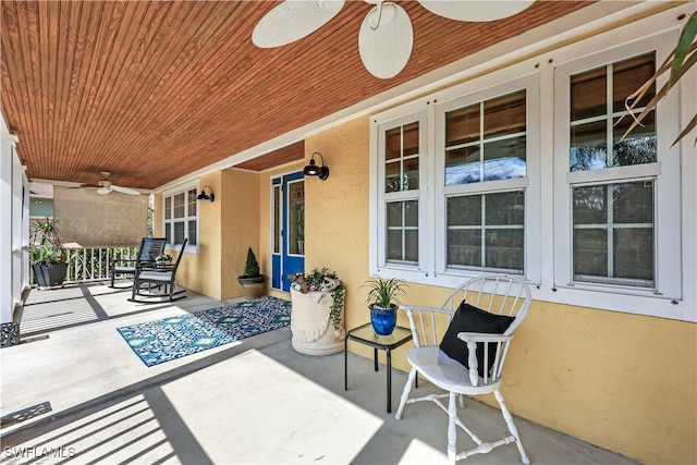 view of patio / terrace with ceiling fan and a porch