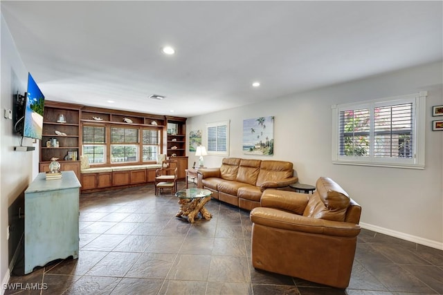 living area featuring baseboards, visible vents, and recessed lighting