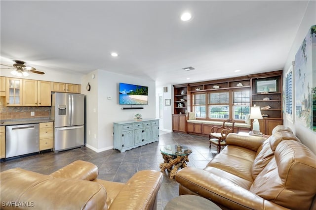 living room featuring recessed lighting, dark tile patterned flooring, ceiling fan, and baseboards