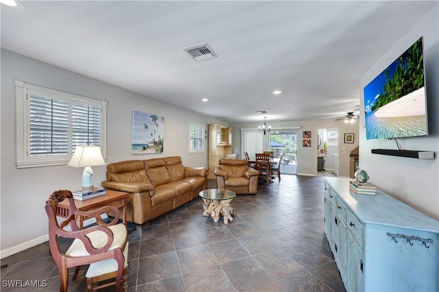 living area with an inviting chandelier, baseboards, visible vents, and recessed lighting