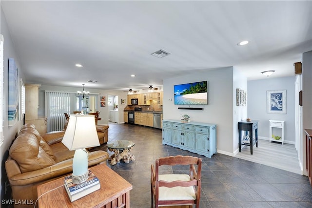 living room featuring baseboards, ceiling fan with notable chandelier, visible vents, and recessed lighting