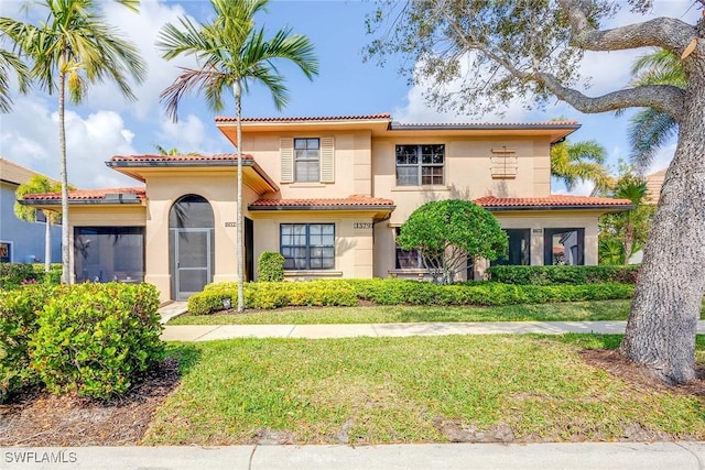 mediterranean / spanish-style house with a front lawn