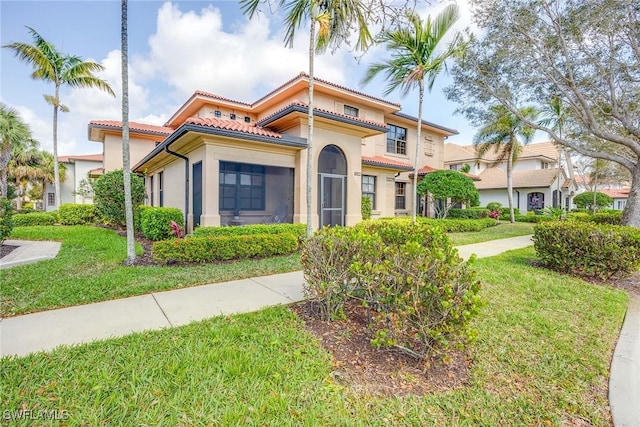 mediterranean / spanish house with a front yard