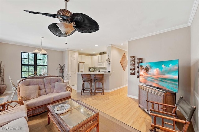 living room with crown molding, ceiling fan, and light wood-type flooring