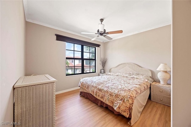 bedroom with crown molding, ceiling fan, and light wood-type flooring