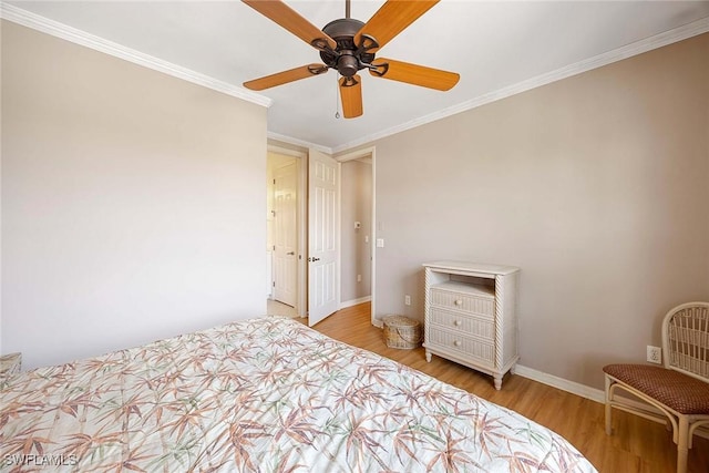 bedroom with crown molding, ceiling fan, and light hardwood / wood-style flooring