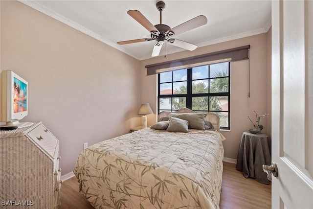 bedroom featuring crown molding, light hardwood / wood-style flooring, and ceiling fan