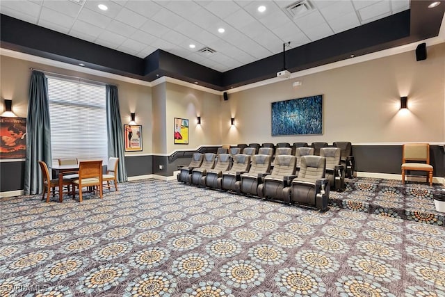 home theater with carpet floors and a tray ceiling