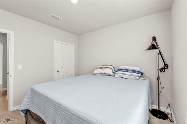 16031 Alcira Cir, Punta Gorda, FL 33955 - bedroom with visible vents, baseboards, and light colored carpet