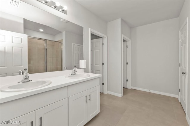 16031 Alcira Cir, Punta Gorda, FL 33955 - full bathroom with a sink, a stall shower, double vanity, and visible vents