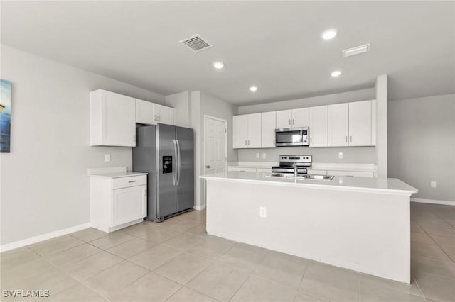 kitchen with visible vents, stainless steel appliances, a sink, and light countertops