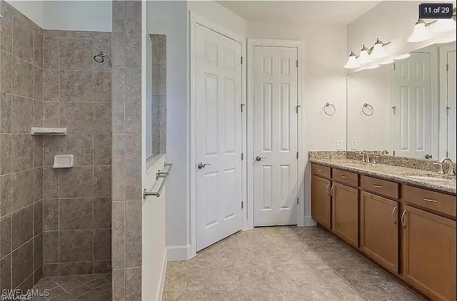 bathroom featuring a tile shower and vanity