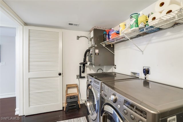 laundry room with dark hardwood / wood-style flooring and washer and dryer