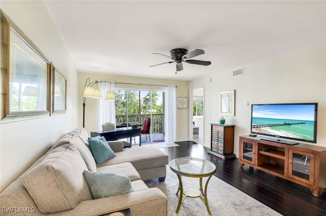 living room with ceiling fan and dark hardwood / wood-style floors