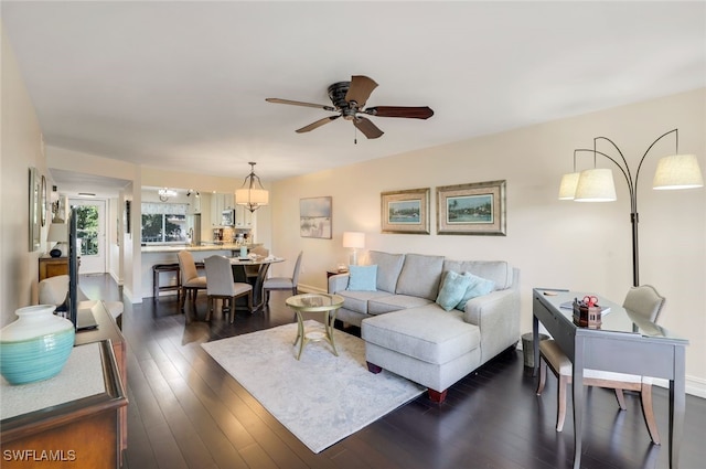 living room with ceiling fan and dark hardwood / wood-style floors