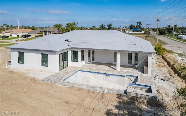 rear view of property featuring a patio