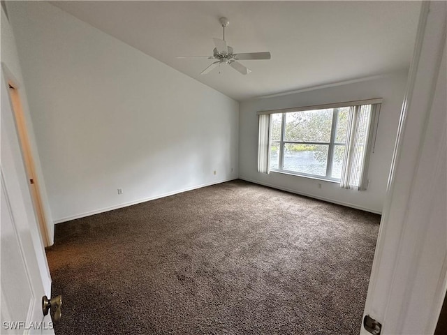 empty room with lofted ceiling, carpet floors, and ceiling fan