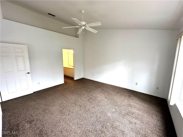 unfurnished bedroom with dark colored carpet, ceiling fan, and high vaulted ceiling