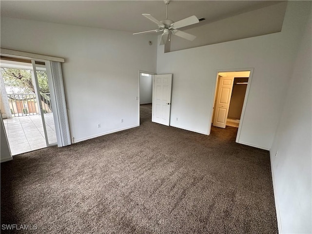 unfurnished bedroom with dark colored carpet, ceiling fan, access to exterior, and high vaulted ceiling