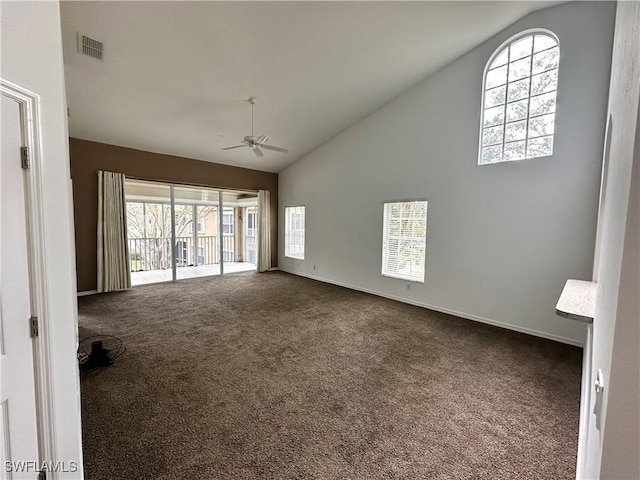 unfurnished living room with high vaulted ceiling, ceiling fan, and carpet