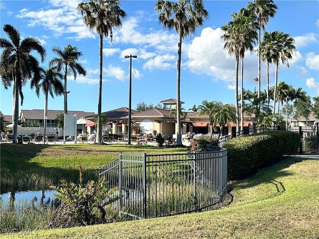 surrounding community featuring a yard and a water view