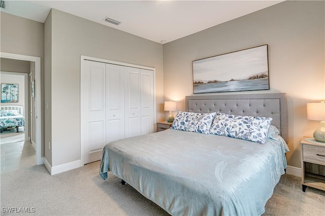 bedroom with a closet and light colored carpet