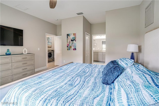 bedroom featuring ensuite bathroom, ceiling fan, and washer / dryer