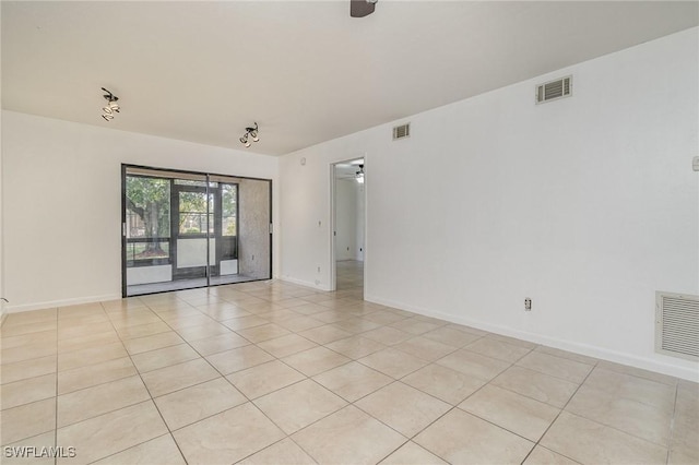 tiled spare room with ceiling fan